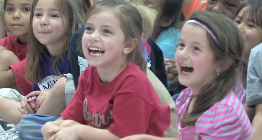 Students laughing at the James Wand school show